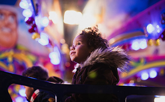 child surrounded by lights